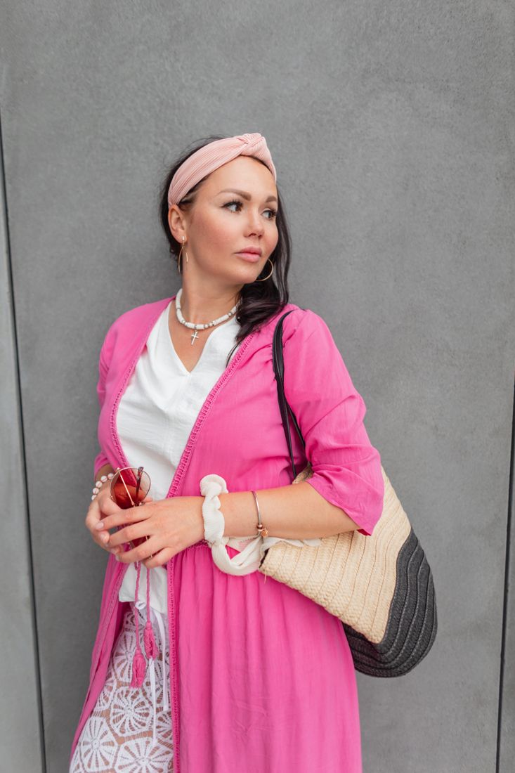 Model in a pink kimono posing outdoors