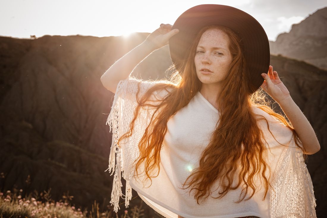 Woman with freckles in a floppy hat