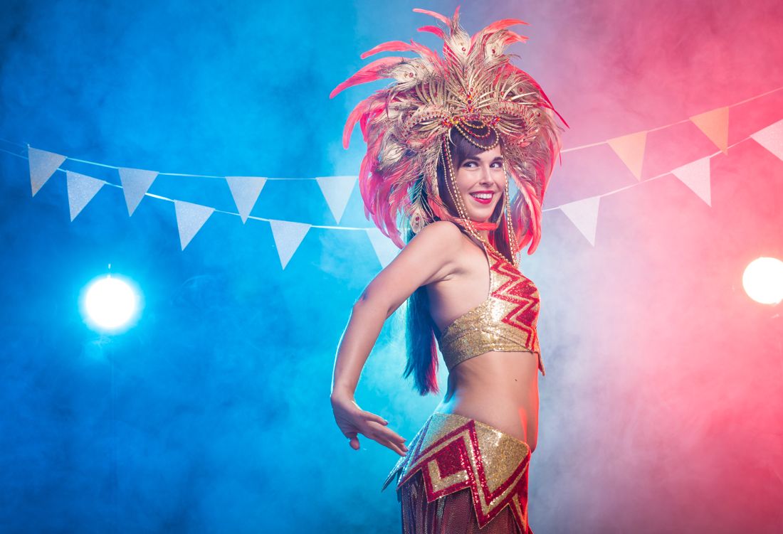 Dancer in a feathered carnival costume on stage