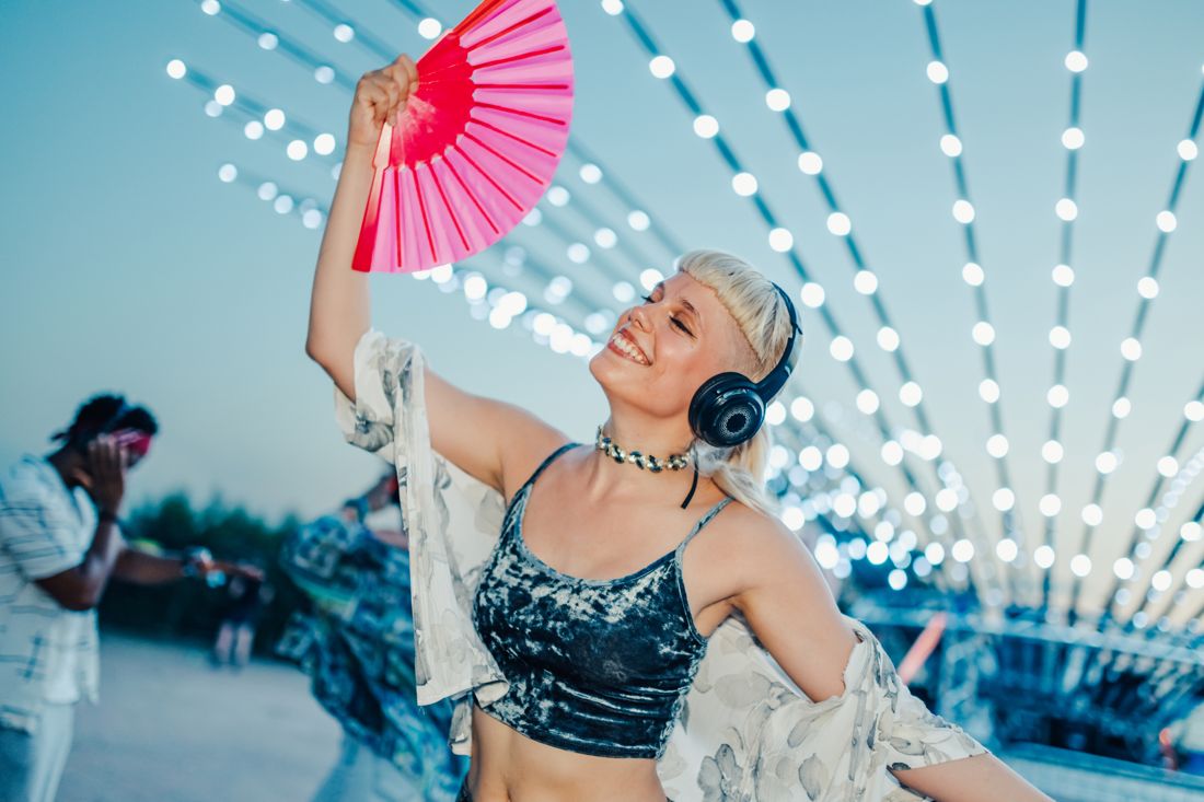 Dancer with a fan under night lights