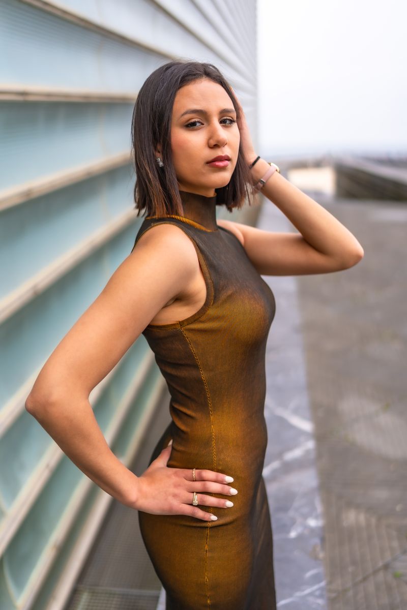 Glamorous woman in the city at dusk