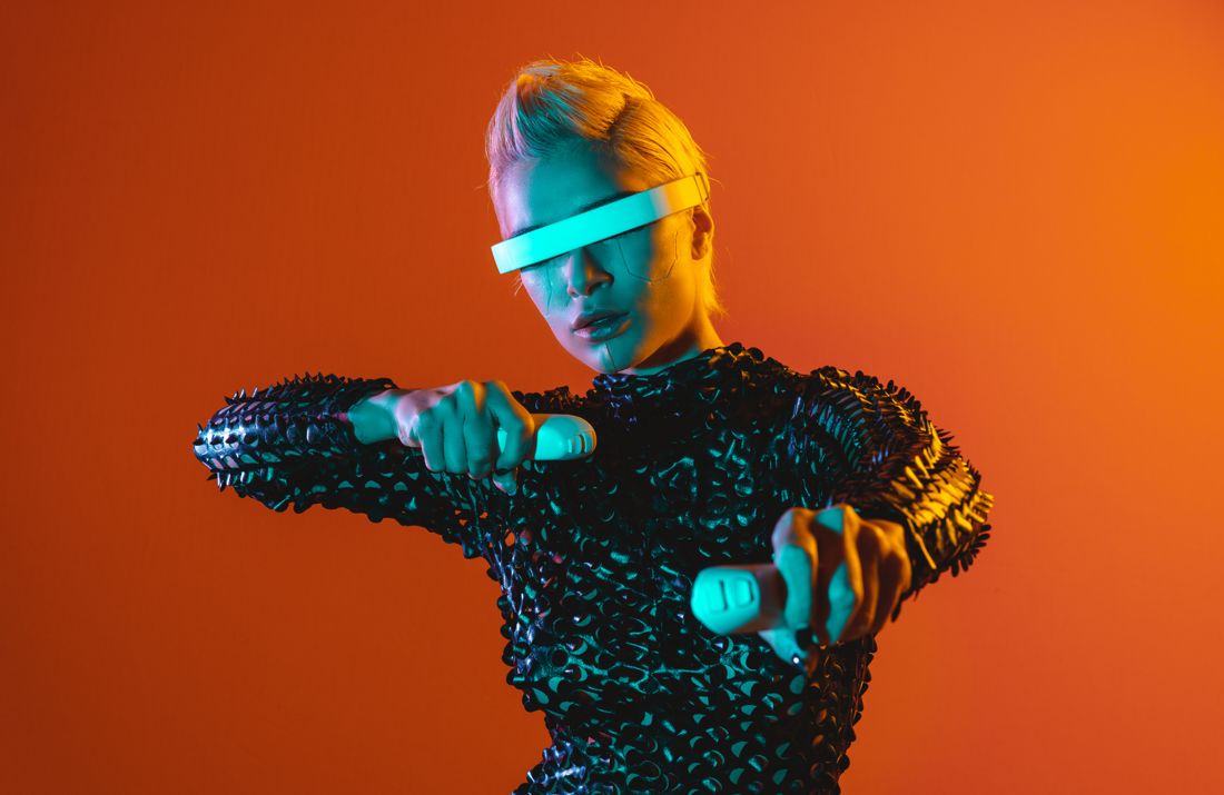 Futuristic visor and controllers against orange