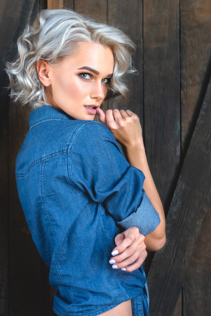 Model posing in a denim shirt