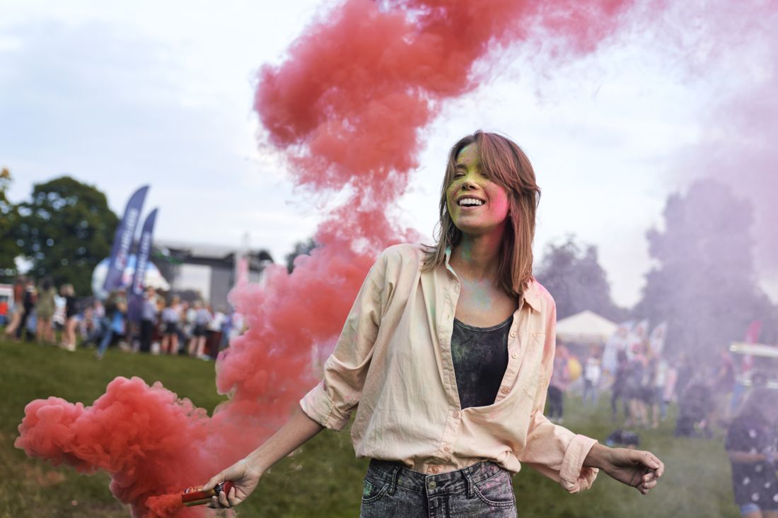 Pink smoke floating across a field portrait