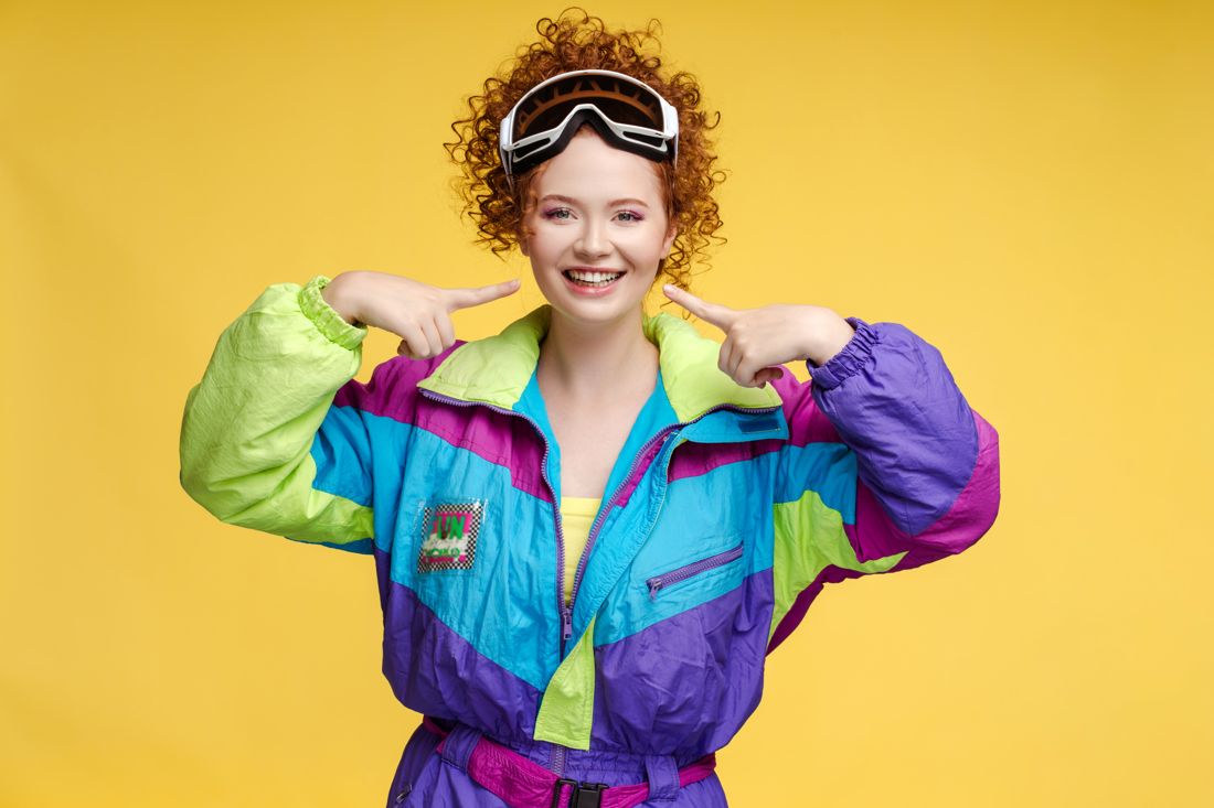 Color-block 80s windbreaker and ski goggles against yellow