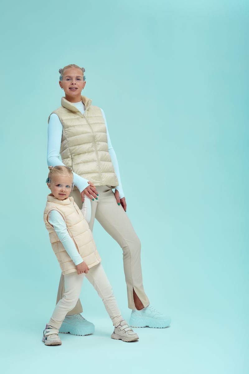 Parent and child in coordinated outfits in a studio