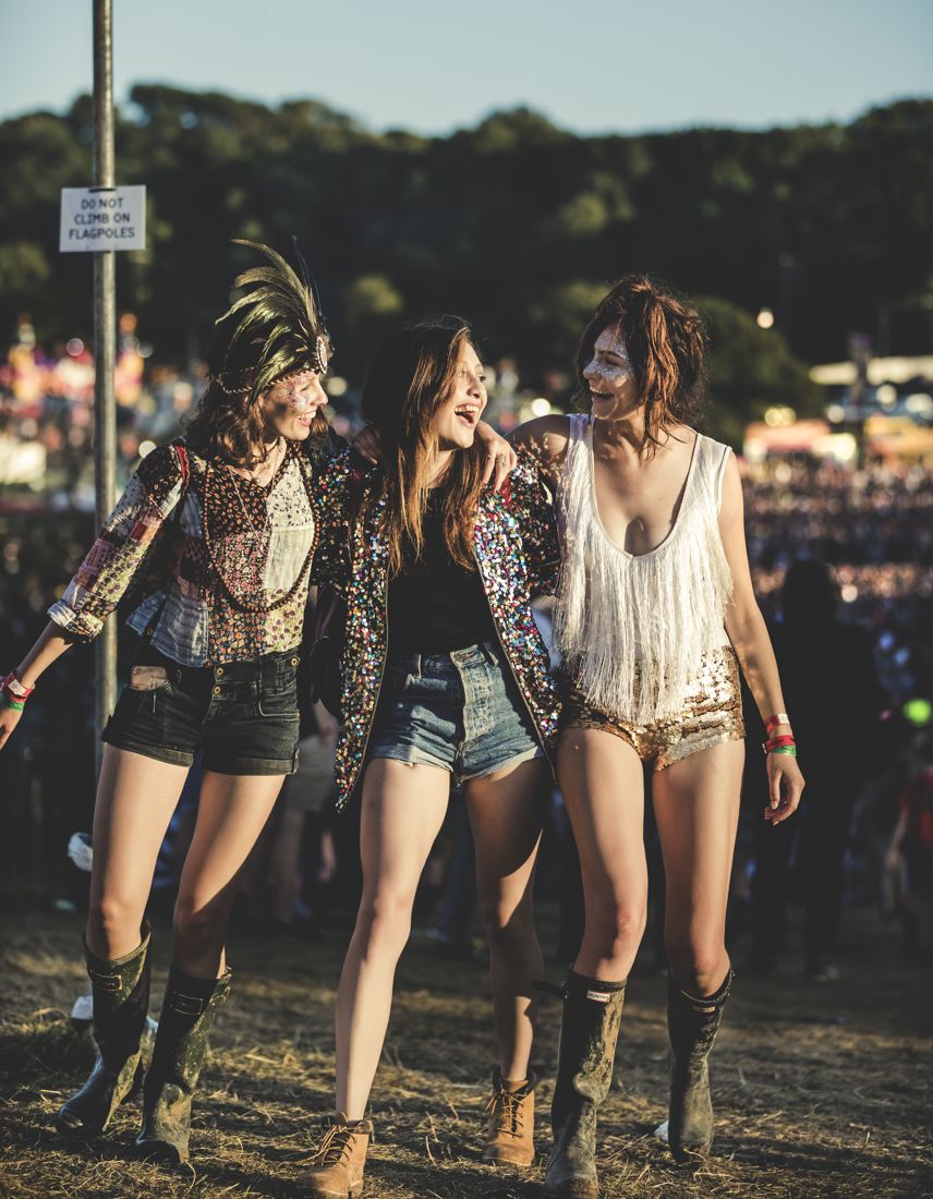 Group in boho festival wear walking at dusk