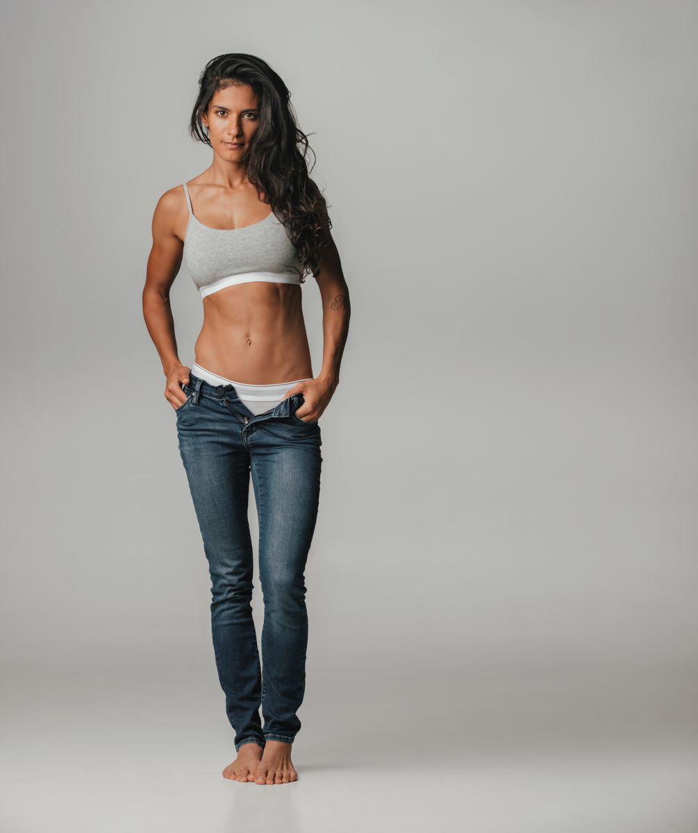 Athlete in sports bra and jeans in studio