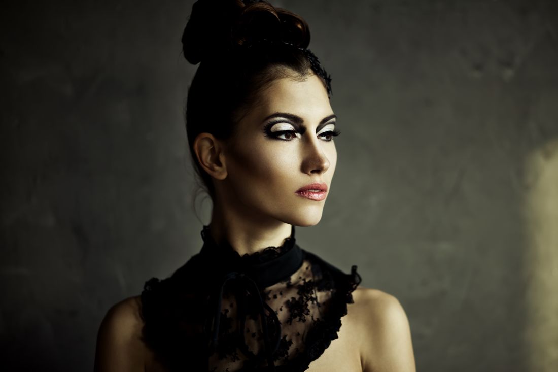 Dark-haired model in black lace with dramatic makeup