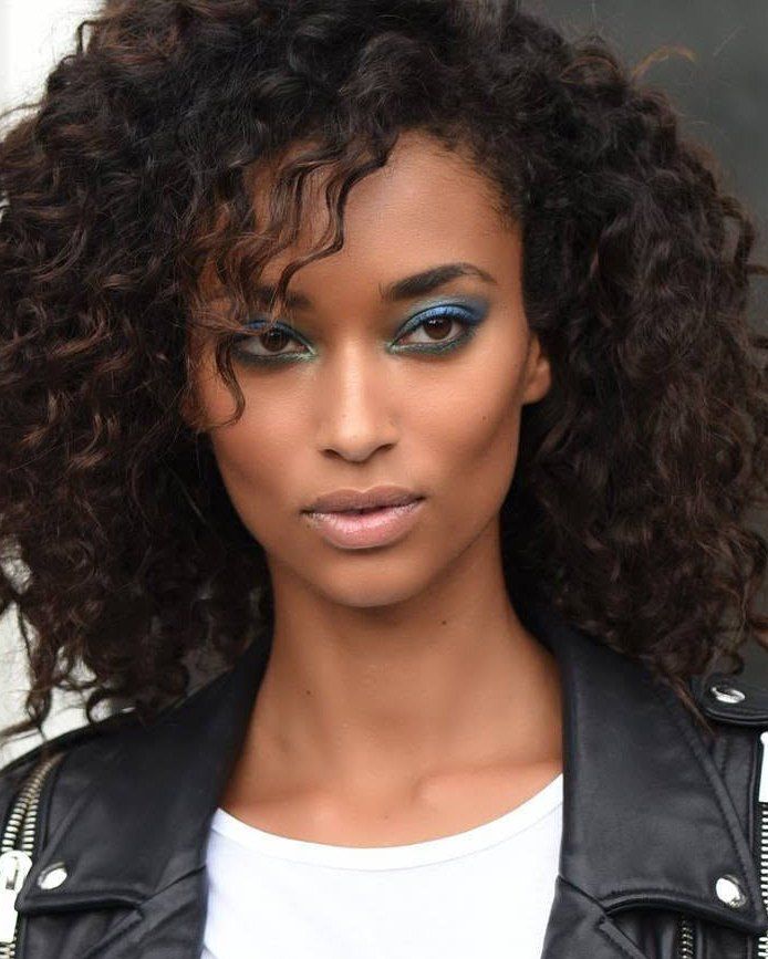 Natural-light portrait with curly hair and a leather jacket