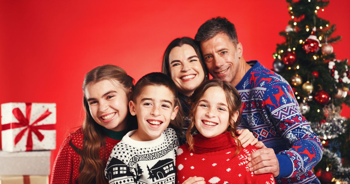 Family in red holiday outfits in a studio portrait
