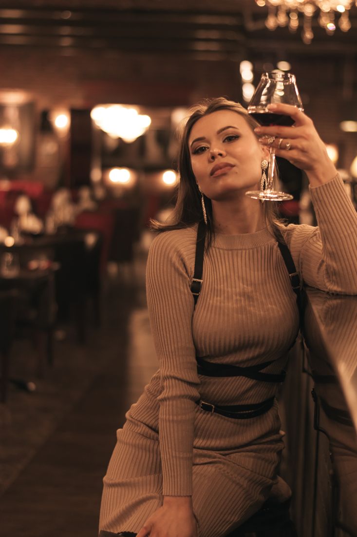 Elegant woman at a bar with a glass