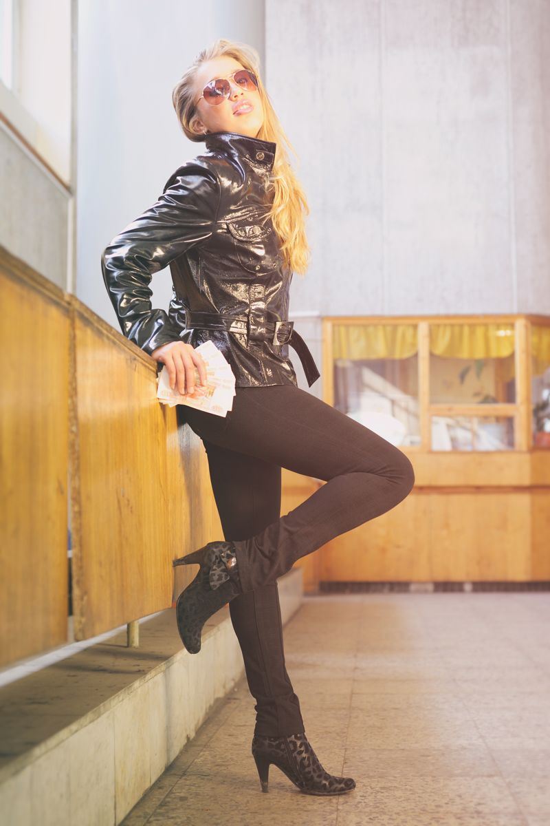 Model in patent coat and boots