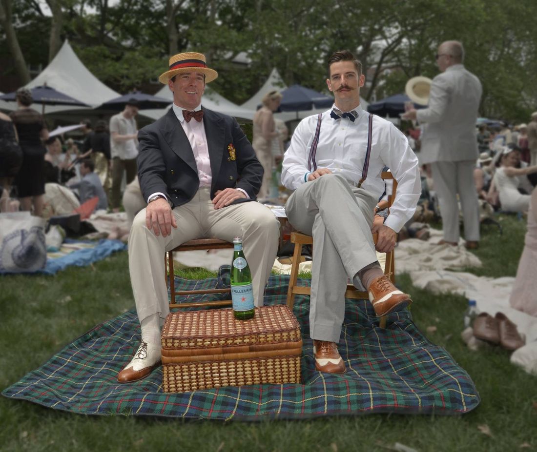 Vintage 1920s-styled picnic on a lawn with wicker basket