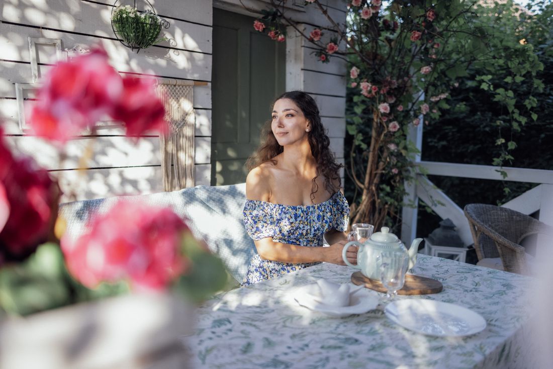 Relaxing in a garden with flowers and tea