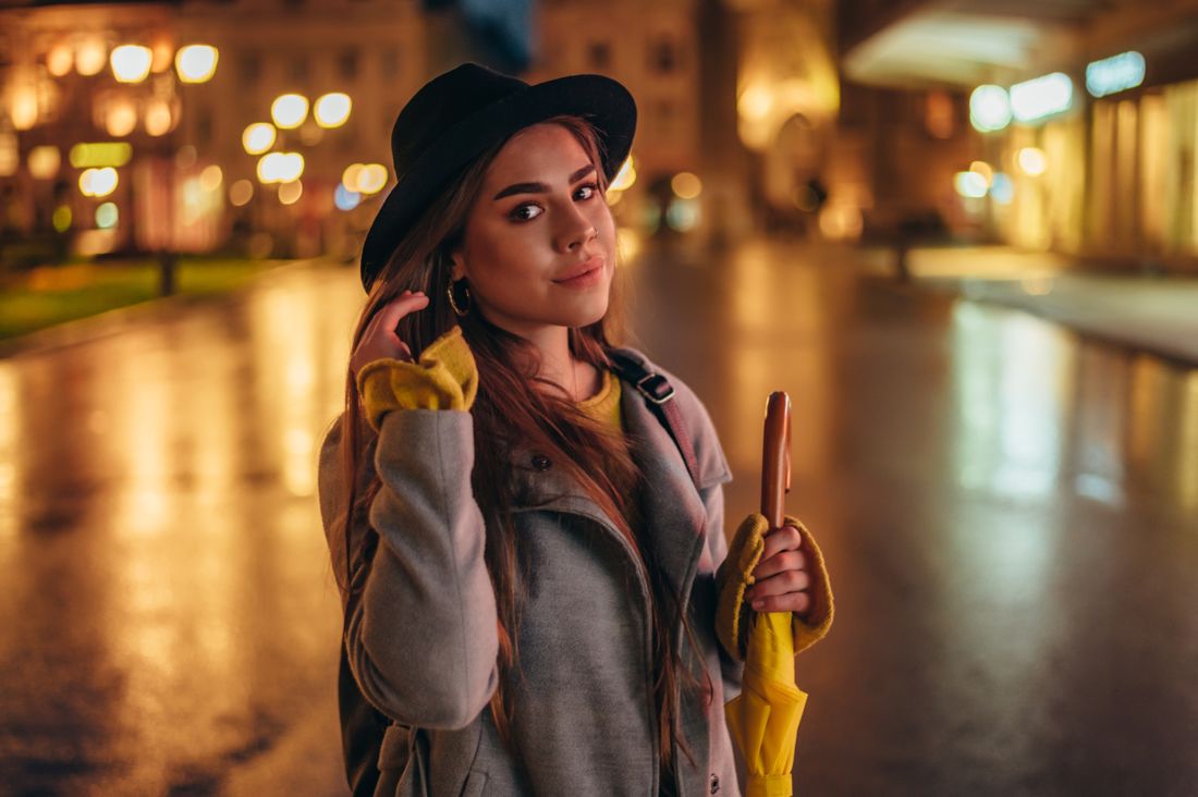 Elegant portrait with an umbrella in golden night light