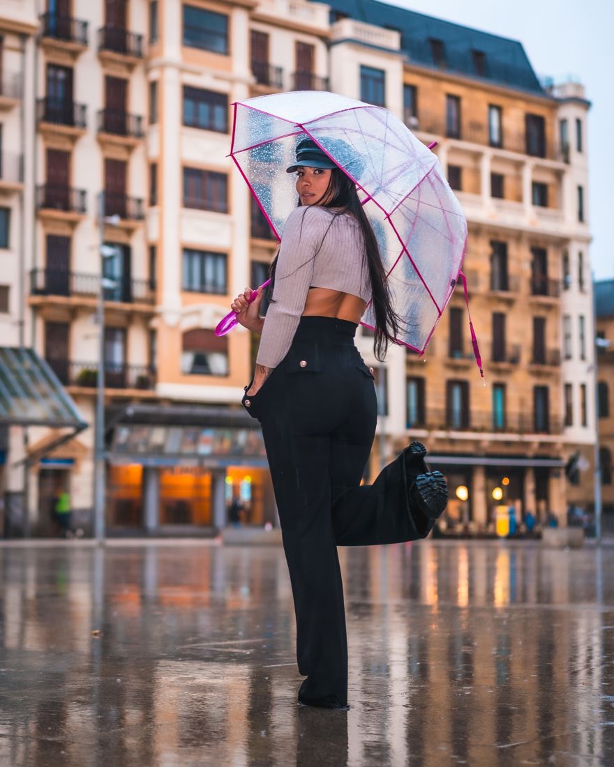 Street style with umbrella on a rainy city evening