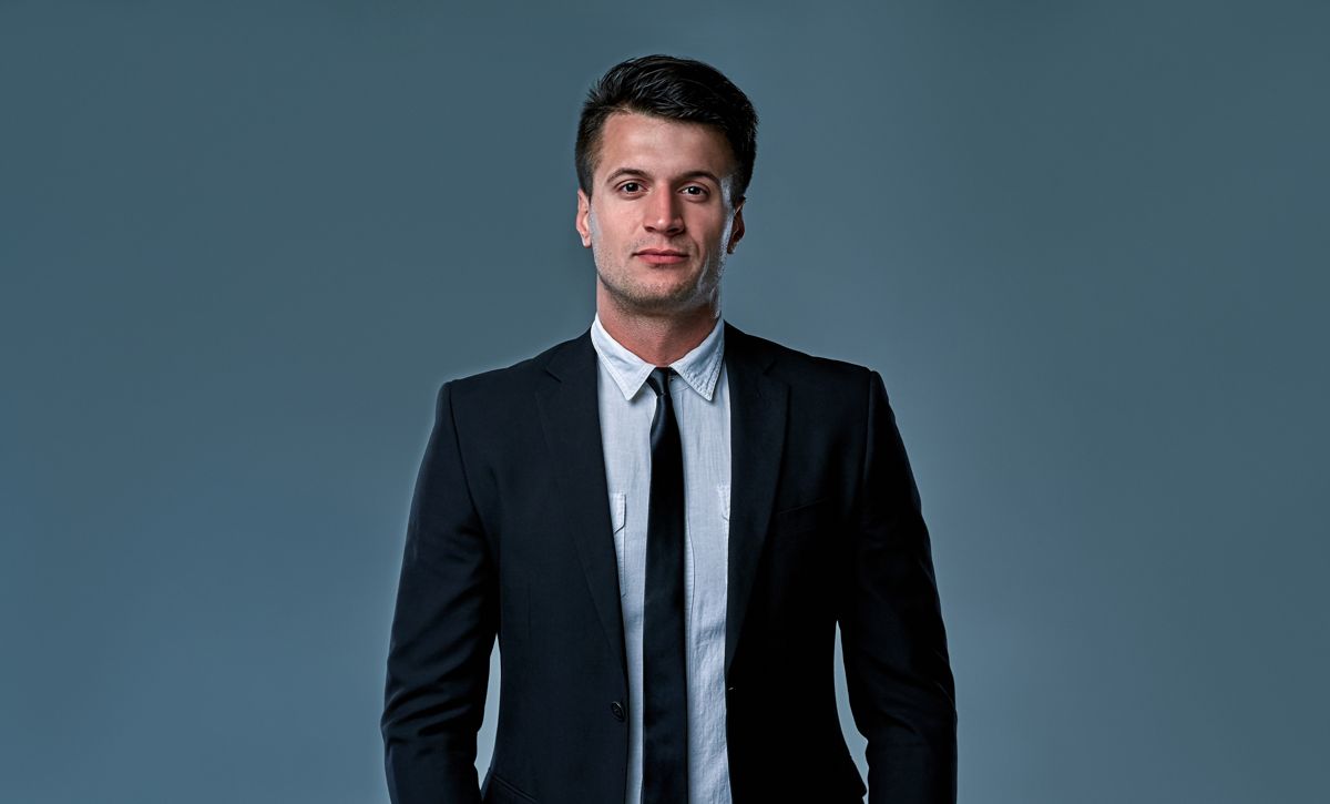 Man in a dark suit and tie, studio portrait
