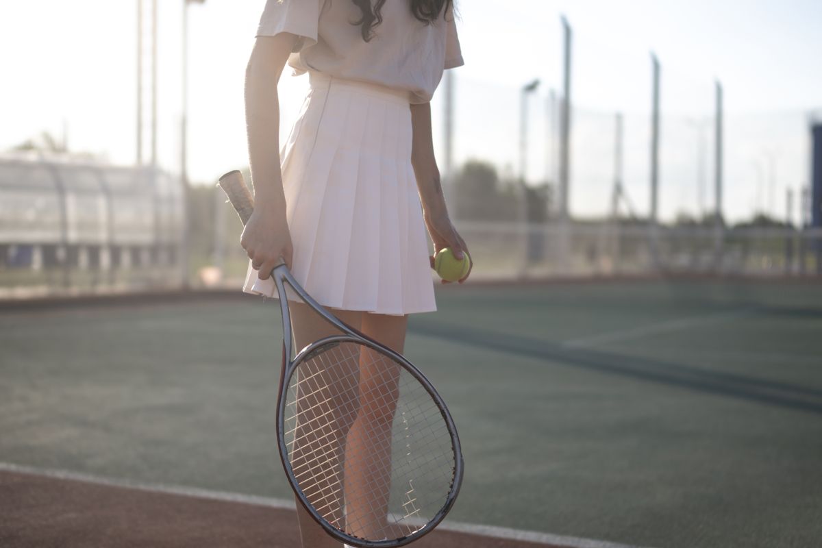 Close-up of a white tennis skirt on court