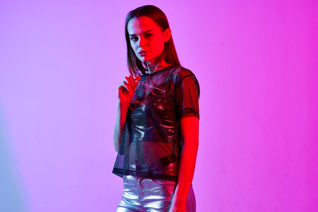 Model in a mesh top and futuristic glasses